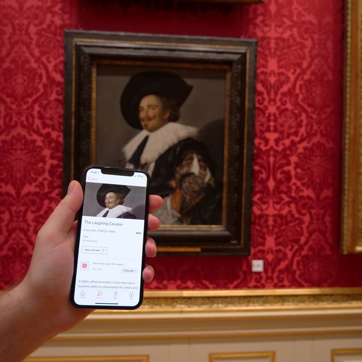 View through a door frame of paintings on gallery wall