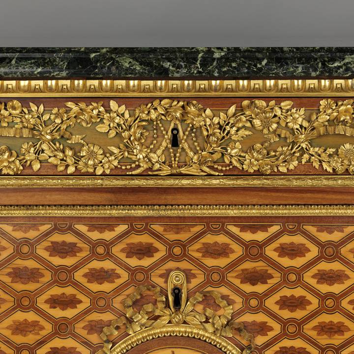 A detail of the gilt-bronze floral frieze mount on a marquetry chest of drawers