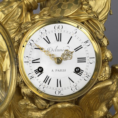 A detail of the dial of a gilt-bronze mantel clock