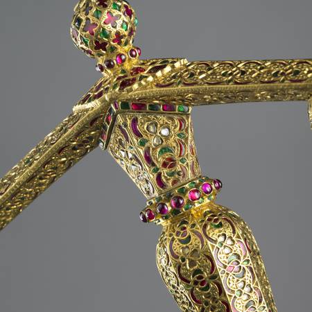 Ornate detail of gold jewelled dagger handle