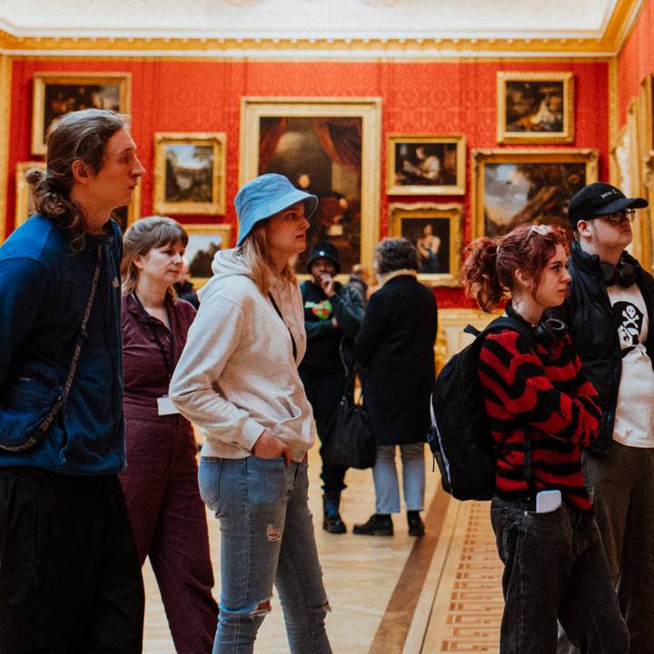 View through a door frame of paintings on gallery wall