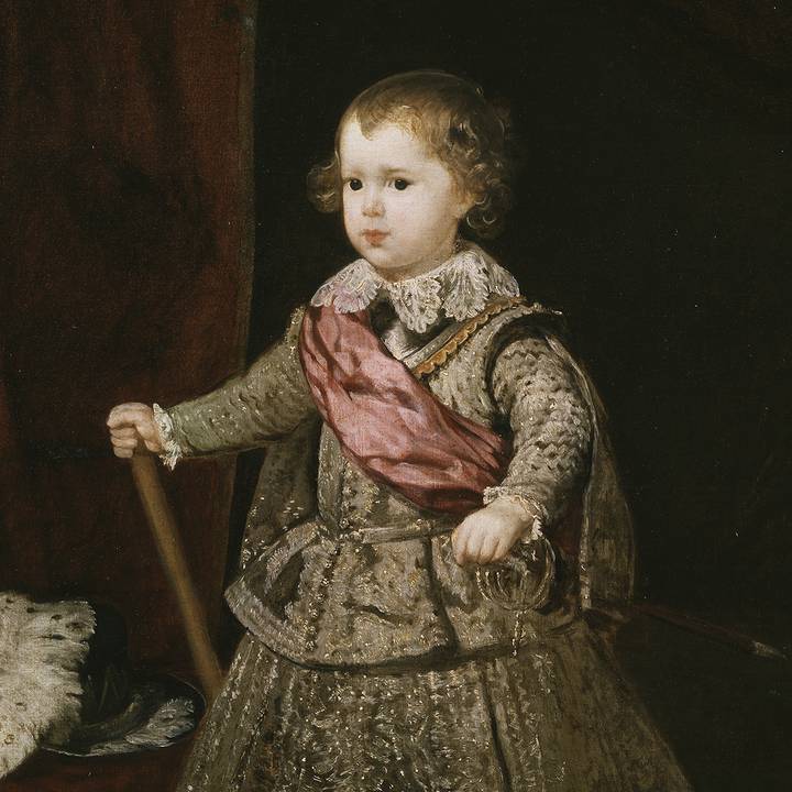 Full length portrait of young boy in costume holding baton