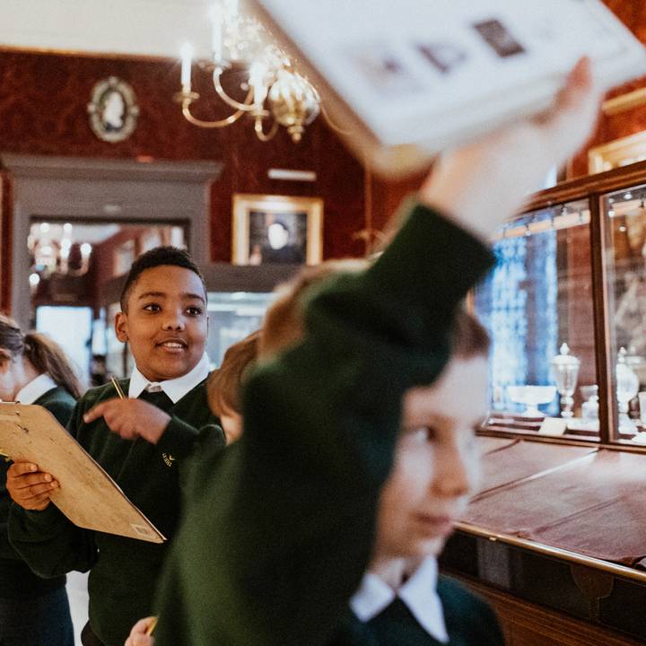 Teacher and student looking at arms and armour in the galleries