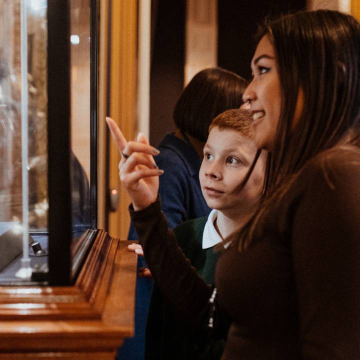 Teacher and student looking at arms and armour in the galleries