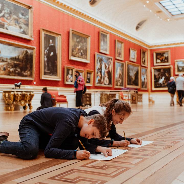 Teacher and student looking at arms and armour in the galleries