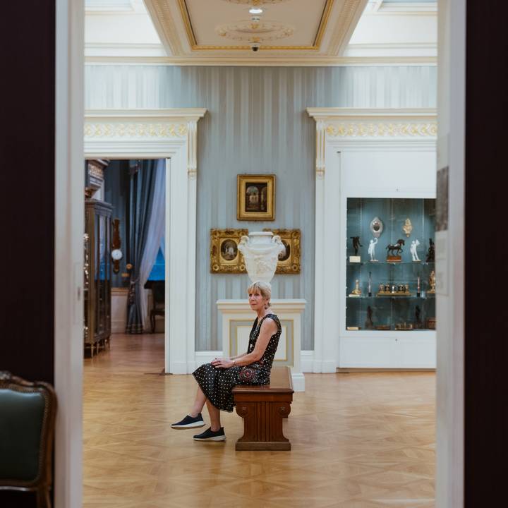 View through a door frame of paintings on gallery wall